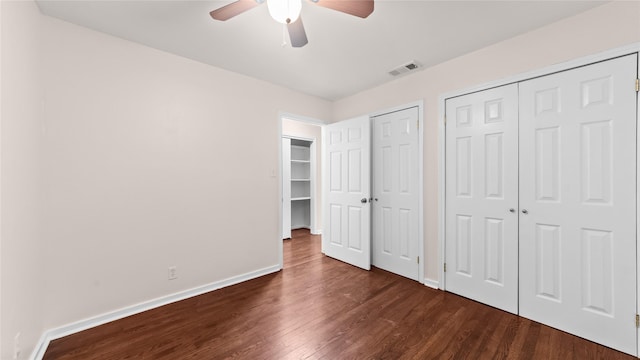 9643 Val Verde St, Houston, TX 77063 - unfurnished bedroom featuring dark wood finished floors, multiple closets, and a ceiling fan