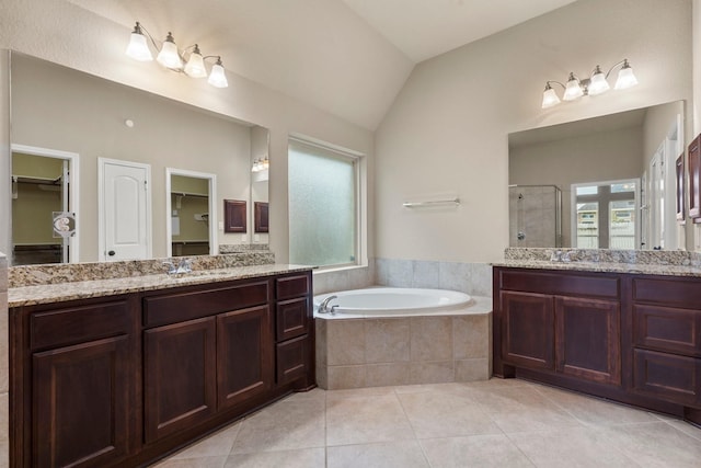1215 Oxbow Crossing Ln, Rosenberg, TX 77471 - bathroom with a stall shower, two vanities, a bath, tile patterned flooring, and a walk in closet