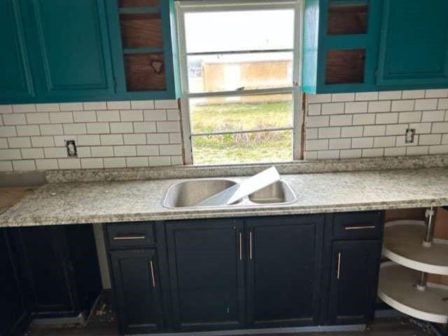 6708 Hawthorne Rd, Hitchcock, TX 77563 - kitchen featuring backsplash, light countertops, and healthy amount of natural light