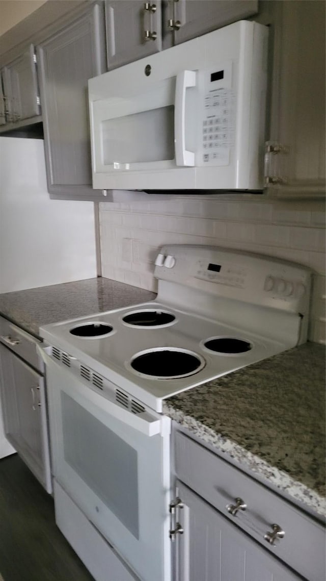 8367 Nairn St, Houston, TX 77074 - kitchen with white appliances, tasteful backsplash, gray cabinetry, and dark wood-style flooring