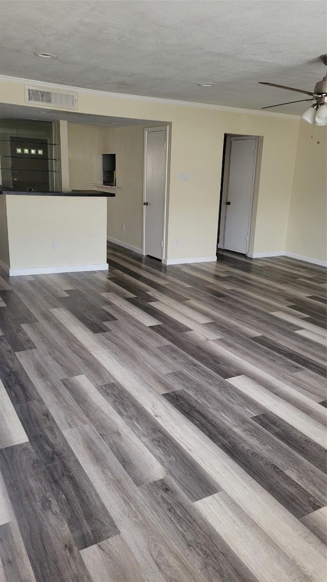 8367 Nairn St, Houston, TX 77074 - unfurnished living room featuring dark wood finished floors, a ceiling fan, and a textured ceiling