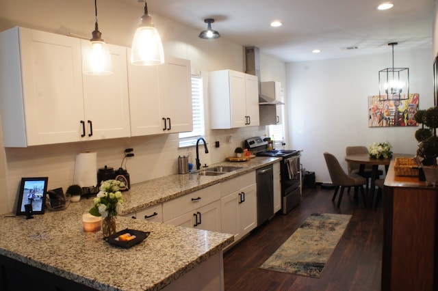 4217 Sterling St, Houston, TX 77051 - kitchen featuring stainless steel appliances, wall chimney exhaust hood, light stone counters, decorative backsplash, and white cabinets