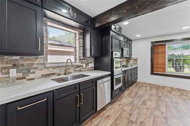 13855 Lantern Ln, Houston, TX 77015 - kitchen with appliances with stainless steel finishes, tasteful backsplash, light wood-type flooring, light stone countertops, and recessed lighting