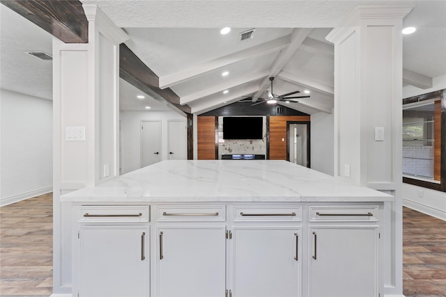13855 Lantern Ln, Houston, TX 77015 - kitchen featuring wood finished floors, a ceiling fan, white cabinetry, light stone countertops, and recessed lighting
