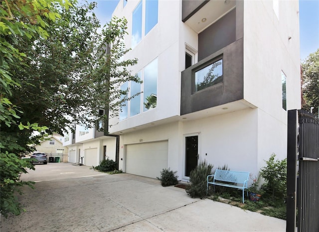 5711 Kansas, Houston, TX 77007 - view of building exterior featuring an attached garage and driveway