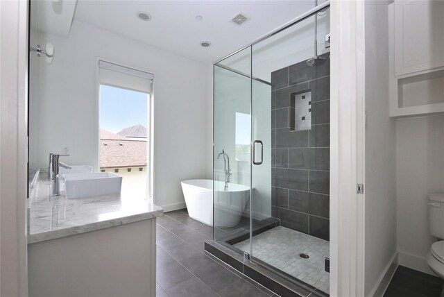 5711 Kansas, Houston, TX 77007 - bathroom featuring a soaking tub, a shower stall, vanity, and tile patterned flooring
