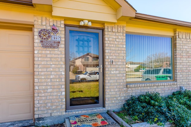 6335 Danshire Ct, Houston, TX 77049 - doorway to property with brick siding and a garage