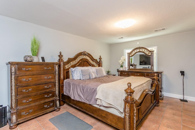 6335 Danshire Ct, Houston, TX 77049 - bedroom featuring light tile patterned flooring and a textured ceiling