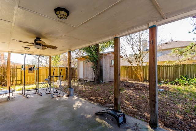 6335 Danshire Ct, Houston, TX 77049 - fenced backyard with a patio, ceiling fan, and an outbuilding