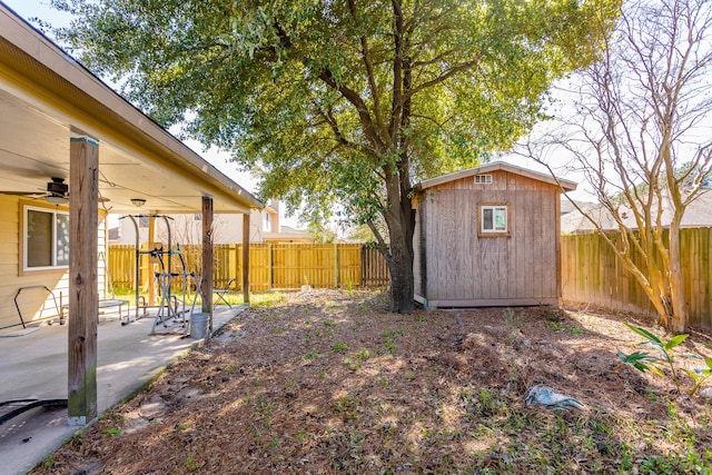 6335 Danshire Ct, Houston, TX 77049 - fenced backyard featuring ceiling fan, a patio area, and a storage unit