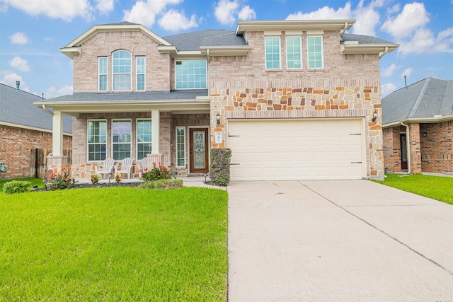 24802 Colonial Maple Dr, Katy, TX 77493 - view of front facade with covered porch, a front yard, driveway, a garage, and brick siding