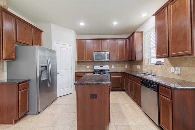 24802 Colonial Maple Dr, Katy, TX 77493 - kitchen with stainless steel appliances, a center island, dark stone counters, decorative backsplash, and recessed lighting