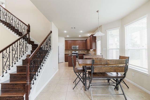 24802 Colonial Maple Dr, Katy, TX 77493 - dining area with healthy amount of natural light, light tile patterned floors, stairway, and recessed lighting