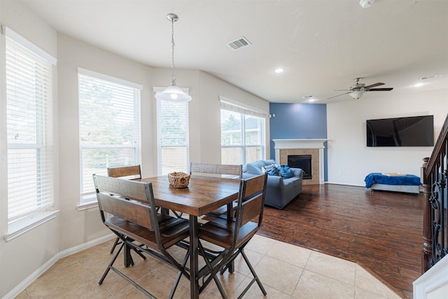 24802 Colonial Maple Dr, Katy, TX 77493 - dining room featuring ceiling fan, light tile patterned floors, a tiled fireplace, and recessed lighting