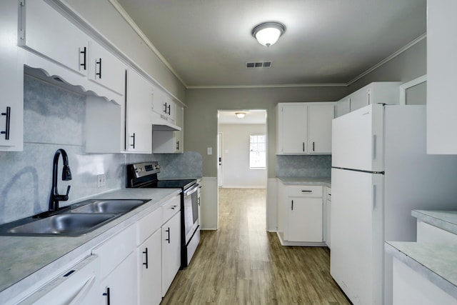 10201 Munn St, Houston, TX 77029 - kitchen featuring white appliances, light wood finished floors, light countertops, crown molding, and decorative backsplash