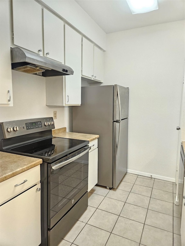 7950 N Stadium Dr Unit 191, Houston, TX 77030 - kitchen featuring appliances with stainless steel finishes, under cabinet range hood, light tile patterned floors, white cabinets, and light countertops