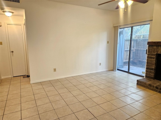 7950 N Stadium Dr Unit 191, Houston, TX 77030 - spare room featuring ceiling fan, a fireplace with raised hearth, and light tile patterned floors