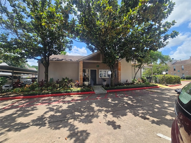 7950 N Stadium Dr Unit 191, Houston, TX 77030 - view of front of property featuring brick siding, stucco siding, and uncovered parking