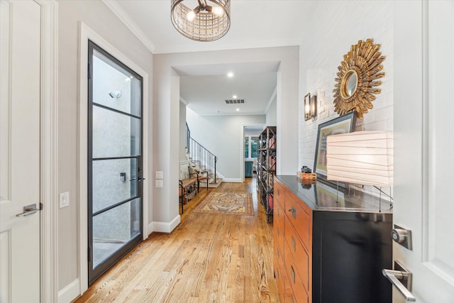 1712 Michigan St, Houston, TX 77006 - foyer entrance featuring light wood-type flooring, stairway, and ornamental molding