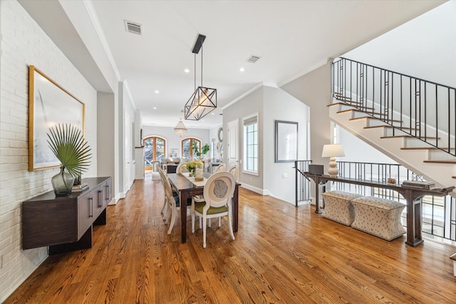 1712 Michigan St, Houston, TX 77006 - dining room featuring wood finished floors, stairway, ornamental molding, a chandelier, and recessed lighting