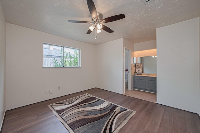 4330 Brookhead Trl, Houston, TX 77066 - unfurnished bedroom featuring wood finished floors, ensuite bath, a textured ceiling, and a ceiling fan