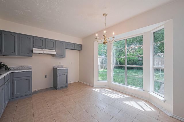 4330 Brookhead Trl, Houston, TX 77066 - kitchen with gray cabinetry, under cabinet range hood, and healthy amount of natural light