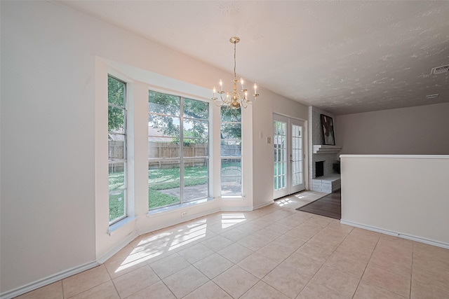 4330 Brookhead Trl, Houston, TX 77066 - unfurnished dining area with a chandelier, plenty of natural light, tile patterned floors, and a brick fireplace