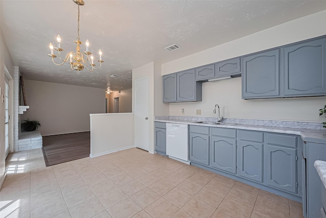 4330 Brookhead Trl, Houston, TX 77066 - kitchen featuring white dishwasher, light tile patterned floors, a chandelier, light countertops, and hanging light fixtures
