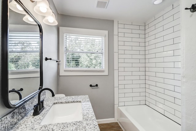 2003 Amelia St, Baytown, TX 77520 - full bathroom featuring healthy amount of natural light, vanity, wood finished floors, and  shower combination