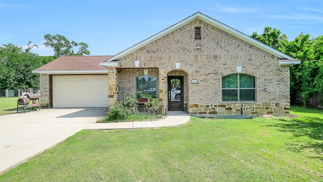 1804 Esther Dr, Houston, TX 77088 - french country style house featuring brick siding, a garage, a front lawn, driveway, and stone siding