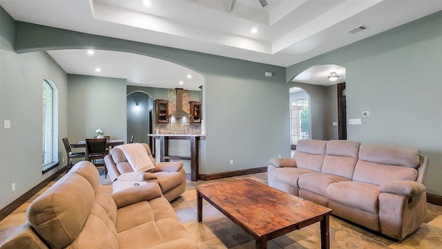 1804 Esther Dr, Houston, TX 77088 - living area featuring arched walkways, recessed lighting, a tray ceiling, and ceiling fan