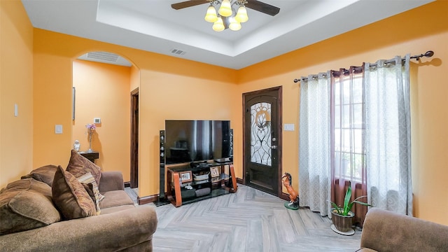 1804 Esther Dr, Houston, TX 77088 - living room with arched walkways, healthy amount of natural light, a ceiling fan, and a raised ceiling