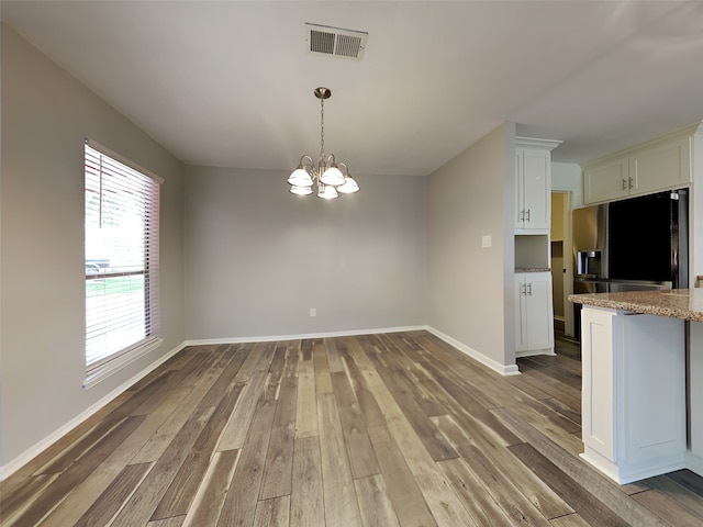 1402 Cherry Springs Ct, Missouri City, TX 77459 - unfurnished dining area featuring light wood-style flooring and a chandelier