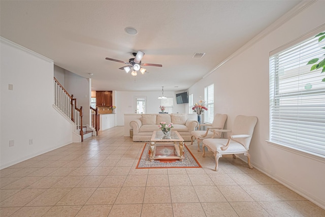 18231 Rexine Ln, Cypress, TX 77433 - living area with stairway, a ceiling fan, light tile patterned floors, and crown molding