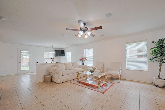 18231 Rexine Ln, Cypress, TX 77433 - living room featuring light tile patterned floors, a ceiling fan, and a chandelier