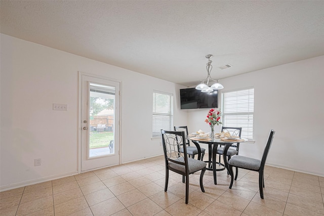 18231 Rexine Ln, Cypress, TX 77433 - dining area with a chandelier, a textured ceiling, and light tile patterned floors