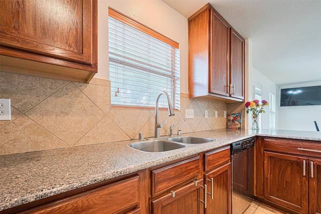 18231 Rexine Ln, Cypress, TX 77433 - kitchen featuring dishwasher, backsplash, plenty of natural light, and brown cabinetry