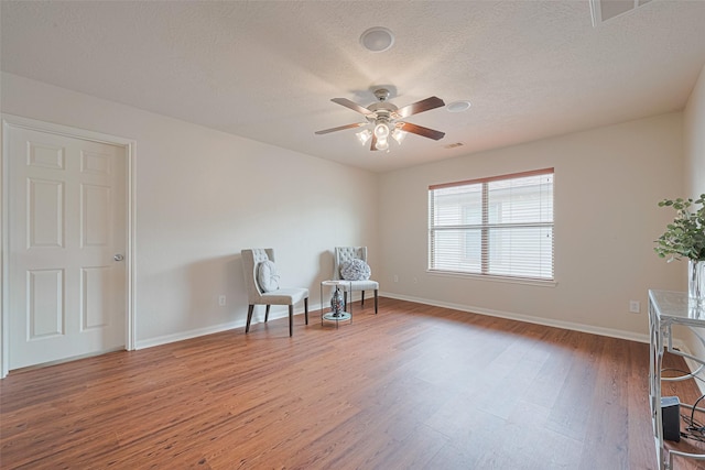 18231 Rexine Ln, Cypress, TX 77433 - sitting room featuring wood finished floors, ceiling fan, and a textured ceiling