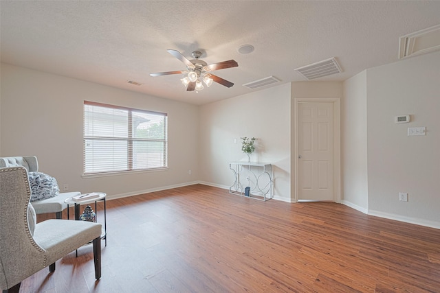 18231 Rexine Ln, Cypress, TX 77433 - sitting room featuring ceiling fan, wood finished floors, and a textured ceiling