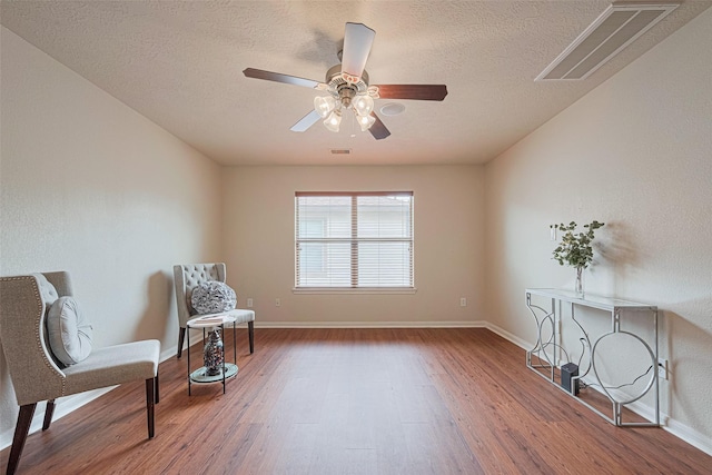 18231 Rexine Ln, Cypress, TX 77433 - sitting room featuring wood finished floors, a textured ceiling, and a ceiling fan