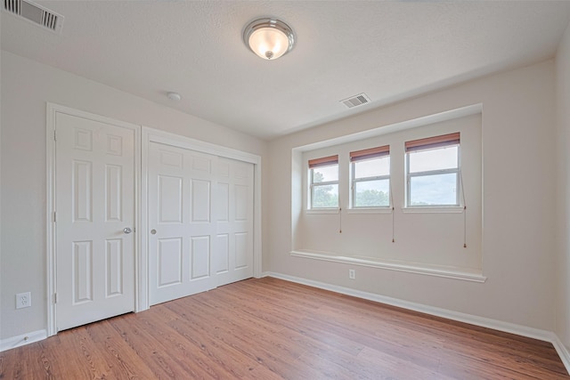 18231 Rexine Ln, Cypress, TX 77433 - unfurnished bedroom featuring light wood-style flooring and a closet