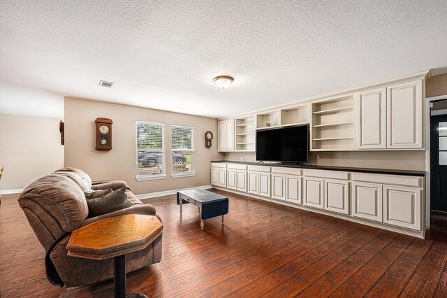 7403 Falcon Dr, Brookshire, TX 77423 - living area with dark wood-style floors and a textured ceiling