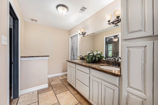 7403 Falcon Dr, Brookshire, TX 77423 - bathroom with double vanity, stone tile flooring, and ceiling fan