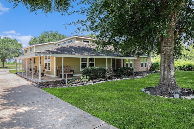 7403 Falcon Dr, Brookshire, TX 77423 - view of front of house with a porch and a front lawn