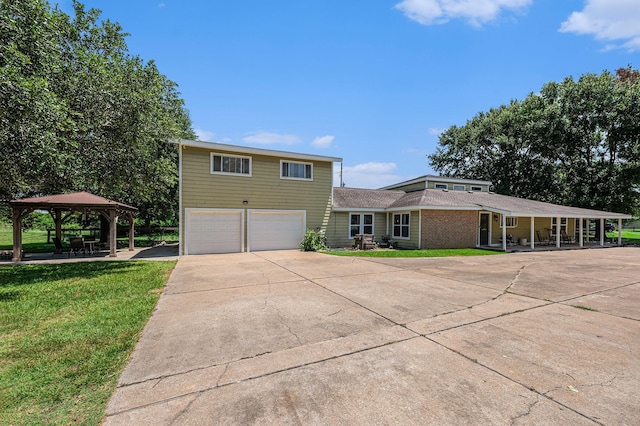 7403 Falcon Dr, Brookshire, TX 77423 - view of front facade featuring an attached garage, a gazebo, a front yard, and driveway