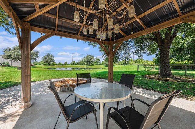 7403 Falcon Dr, Brookshire, TX 77423 - view of patio / terrace featuring a fire pit, a gazebo, a water view, and outdoor dining space