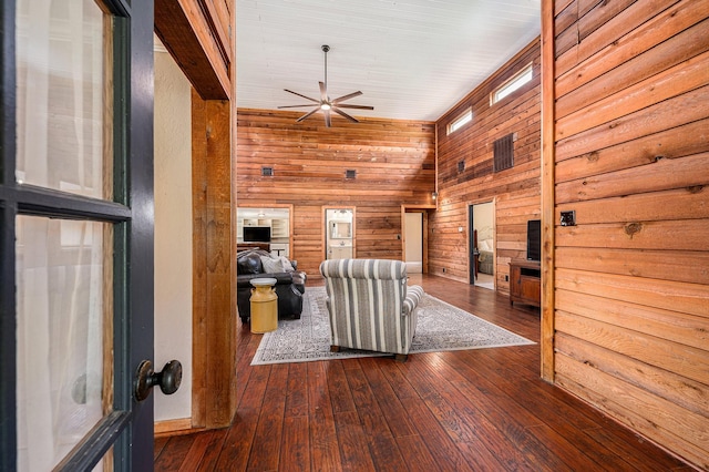 7403 Falcon Dr, Brookshire, TX 77423 - living room featuring a ceiling fan, hardwood / wood-style floors, and wood walls