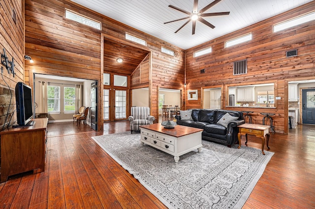 7403 Falcon Dr, Brookshire, TX 77423 - living area with high vaulted ceiling, wood walls, a ceiling fan, and dark wood finished floors