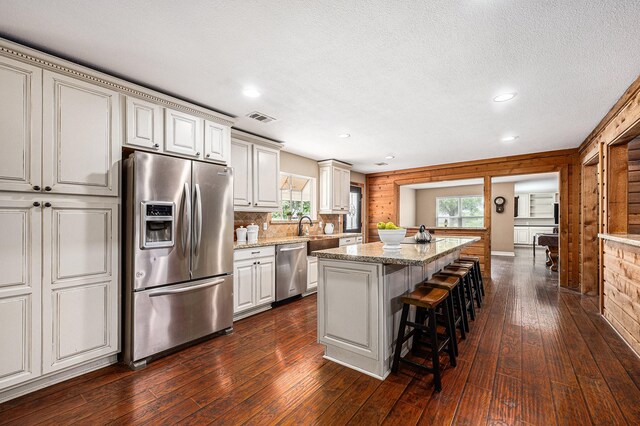 7403 Falcon Dr, Brookshire, TX 77423 - kitchen featuring stainless steel appliances, dark wood-style floors, a kitchen island with sink, healthy amount of natural light, and recessed lighting