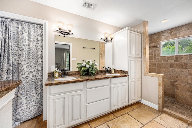 7403 Falcon Dr, Brookshire, TX 77423 - full bath featuring a walk in shower, double vanity, stone tile floors, and recessed lighting